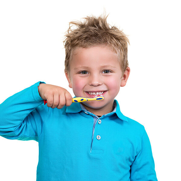 Little boy smiling and brushing teeth